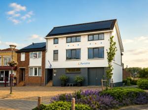 a house with solar panels on the roof at L'Ancora in Sint Annaland