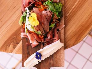 a plate of food on a wooden table at ibis Styles Pont du Gard Route d'Avignon in Estézargues