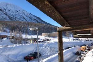 a group of cars parked in the snow at Appartement Montgenevre pied de pistes in Montgenèvre +3 photos