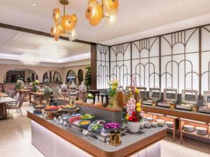 a buffet line in a restaurant with a lot of food at Mercure Lanzhou West in Lanzhou