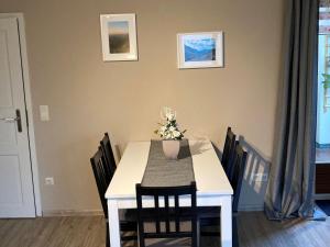 a dining room table with a vase of flowers on it at Ferienwohnung Tannenhöh in Todtmoos