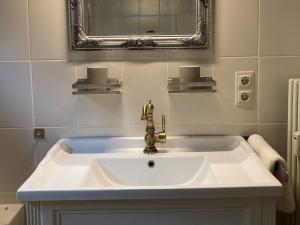 a bathroom with a sink and a mirror at Ferienwohnung Tannenhöh in Todtmoos +17 photos