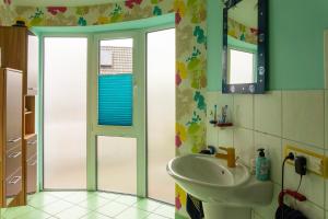 a bathroom with a sink and a mirror at Niederrheinhaus in Rheinberg +14 photos