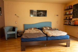 a bedroom with a bed with a blue head board at Niederrheinhaus in Rheinberg
