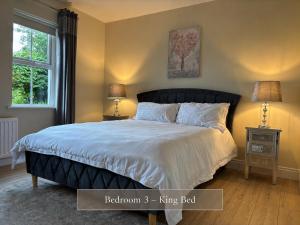 a bedroom with a large bed with two night stands at Sonas in Letterkenny +22 photos