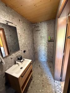 a bathroom with a sink and a mirror at Villas Çeremi in Maskollatë +20 photos