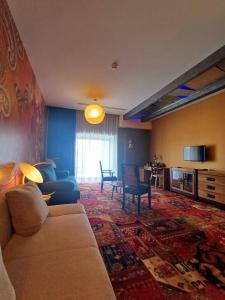 a living room with a couch and a table at Hotel Lenart in Wieliczka