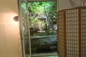 an open door to a garden with a gate at 2 Bedroom-Boho-Style-Apartment in Sankt Veit an der Glan