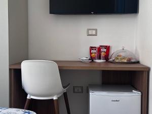 a desk with a chair and a plate of food on it at B&B le Pontine in Gaeta