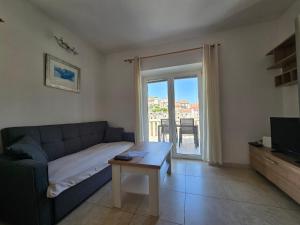 a living room with a couch and a table at Apartment Mladinić Muse in Pučišća