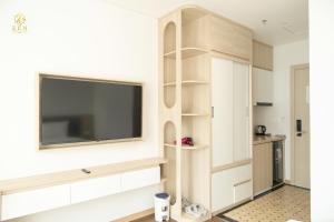 a living room with a tv on a wall at Zen Central Hotel Bac Giang in Bắc Giang