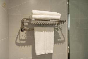 a towel rack with towels on it in a bathroom at Zen Central Hotel Bac Giang in Bắc Giang +23 photos