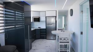 a small kitchen with a table and a refrigerator at Bright & Comfortable 2BR San Juan Getaway in San Juan