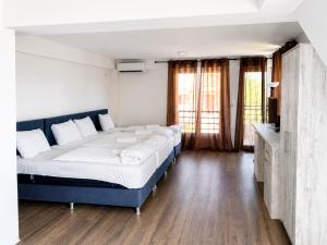 a bedroom with a large bed with white sheets at Nastov Apartments in Veles +8 photos