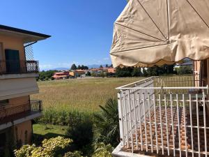 a white staircase with an umbrella next to a house at Mirella's cute place Udine in Udine