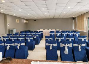 a room filled with blue chairs with white bows at Hotel Aradhana In Mount Abu in Mount Ābu