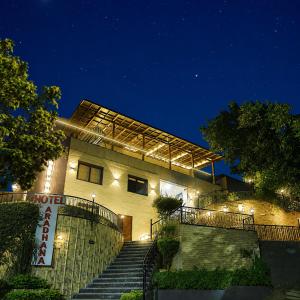 a building with stairs in front of it at night at Hotel Aradhana In Mount Abu in Mount Ābu
