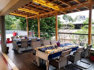 a dining room with long tables and chairs at Hotel Aradhana In Mount Abu in Mount Ābu