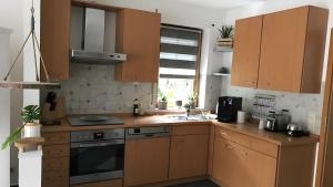 a kitchen with wooden cabinets and a sink at Blue-House Mosel in Piesport