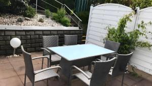 a table and chairs on a patio at Blue-House Mosel in Piesport
