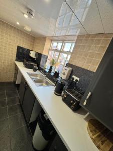 a kitchen with a sink and a counter top at Wakefield Town House Accomodation in Wakefield +28 photos