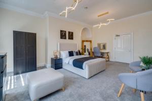 a bedroom with a bed and a table and chairs at Wakefield Town House Accomodation in Wakefield