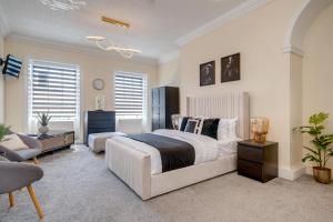 a bedroom with two beds and a chair and a couch at Wakefield Town House Accomodation in Wakefield