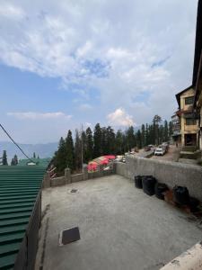 a view of a parking lot next to a building at Hotel Aman in Nārkanda +31 photos