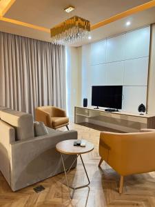 a living room with a couch and a tv at Jacques Georges Tower in Pelotas