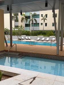 a swimming pool with lounge chairs and a building at Marina private see view room in Abu Dhabi