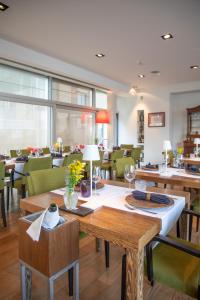 a dining room with tables and green chairs at Dal Moro Gallery Hotel in Assisi +61 photos
