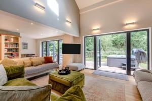 a living room with a couch and a tv at 4 Bed in Ewhurst Green oc-w31032 in Hurst Green