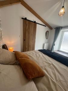 a bedroom with a large bed and a window at L'Escale de Gaston in Sainte-Florence