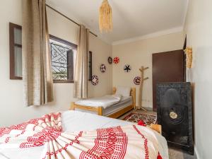 a bedroom with a bed and a window at TAMOUNT Surf House in Agadir