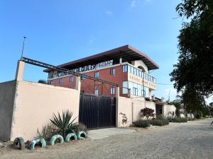 a building with a fence in front of it at Auto Hostal Jaramisol in Jaramijó