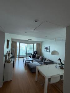 a living room with a couch and a table at Marina private see view room in Abu Dhabi