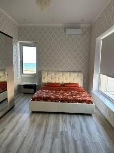 a bedroom with a large bed and a window at Royal resort in Aktau