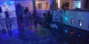 a group of people standing in a room with lights at Auto Hostal Jaramisol in Jaramijó