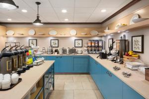 a large kitchen with blue cabinets and appliances at Country Inn & Suites by Radisson, Lexington, KY in Lexington