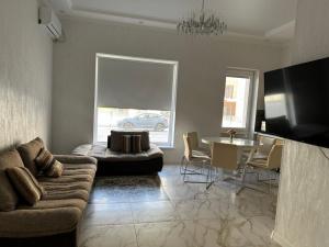 a living room with a couch and a table at Royal resort in Aktau