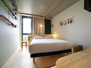 a bedroom with a bed and a table in it at greet hotel Cernay Mulhouse in Cernay +69 photos