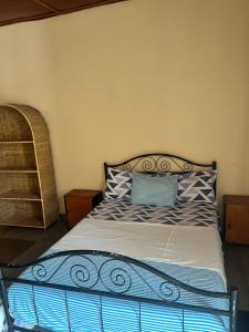 a bed with blue and white pillows in a room at Georgianas Residence in Kartung