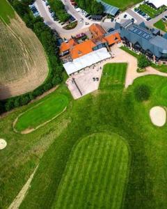 an aerial view of a house with a golf course at A Snuggles hut in Faversham