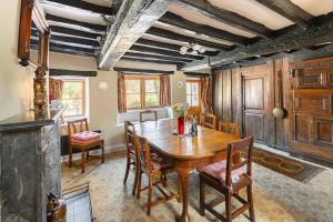 a dining room with a wooden table and chairs at 4 Bed in Hawkshead oc-lr116 in Hawkshead