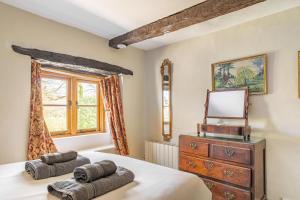 a bedroom with a bed and a dresser and a mirror at 4 Bed in Hawkshead oc-lr116 in Hawkshead