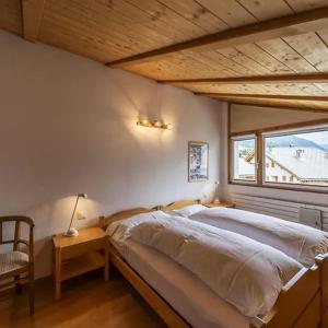 a bedroom with a large bed and a window at Zimmer in Celerina in Celerina