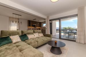 a living room with a couch and a table at Villa Josip in Sukošan