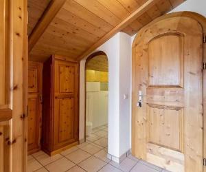 a hallway with a wooden door in a house at Zimmer in Celerina in Celerina +11 photos