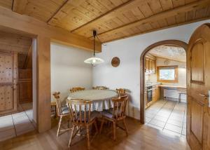 a kitchen and dining room with a table and chairs at Zimmer in Celerina in Celerina