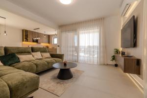 a living room with a couch and a table at Villa Josip in Sukošan